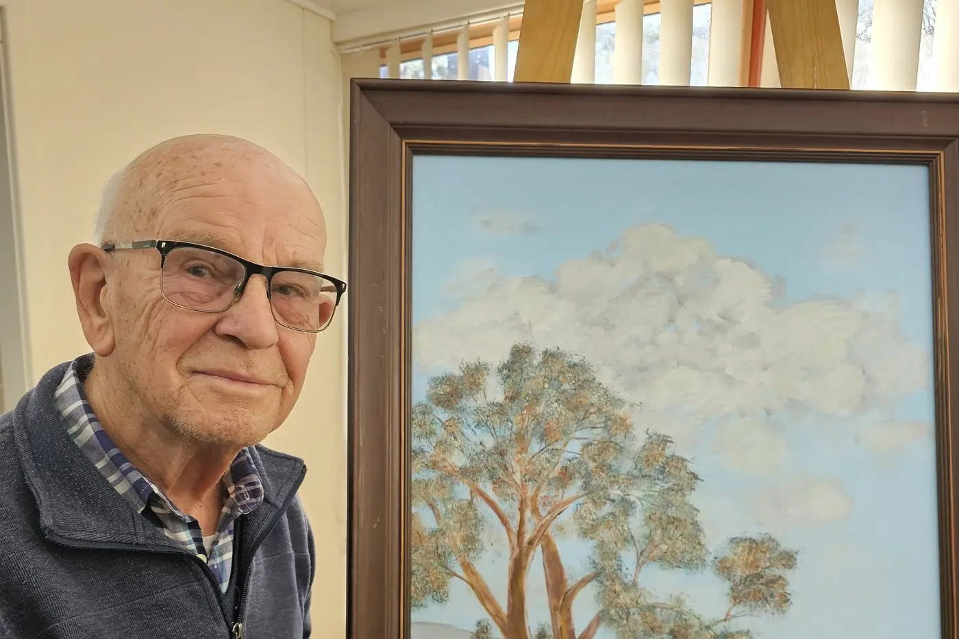 RAGLAN EXHIBITION: Unexpected artist Arno van der Plaat with a landscape that will be part of his family exhibition, Between Cultures, opening at the Raglan Gallery Cooma, March 30. PHOTO: Karen Forman.