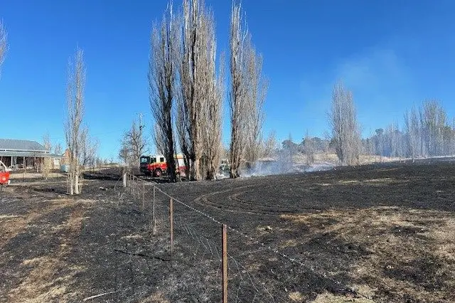 DANGER: Crews mop up after a grass fire rapidly spread at a property on Myalla Rd early last week.\\nPHOTOS: NSWRFS