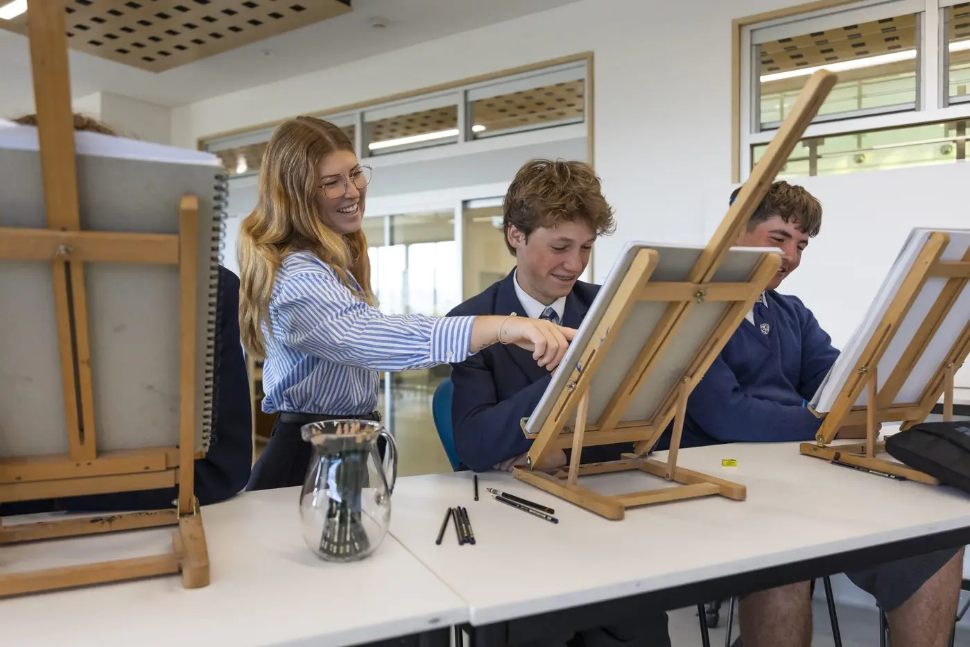 ART: Snowy Mountains Grammar art teacher, Sidney Tulau, with students, Quinn Mesley, and Luka Pasalich. PHOTO: Supplied