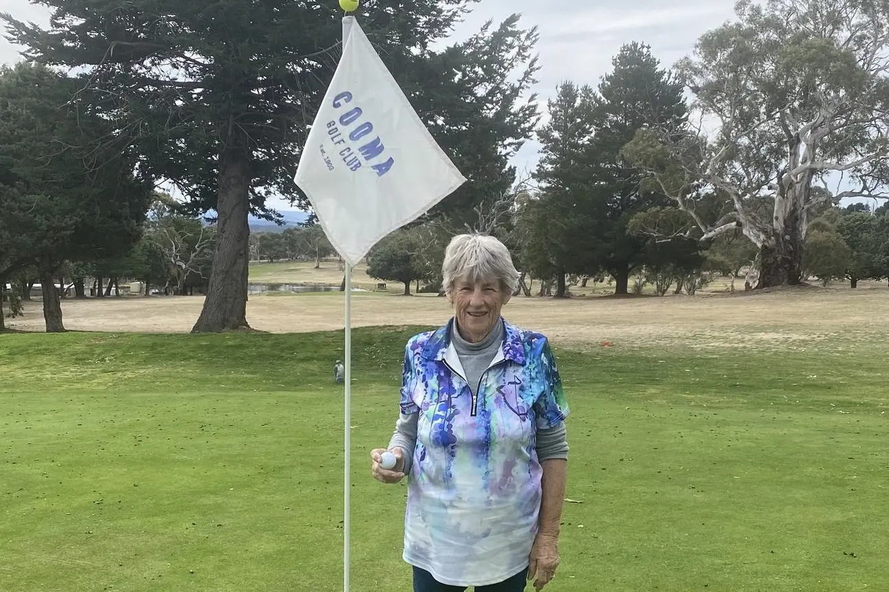 ACE EFFORT: Cooma golfer Helen Crawford collects the ball after her sixth hole-in-one at the Cooma course. Helen\\'s ace on the ninth hole, completes her grand slam of aces, a hole-in-one on each of the course\\'s par three holes. PHOTO: Cooma Golf Club