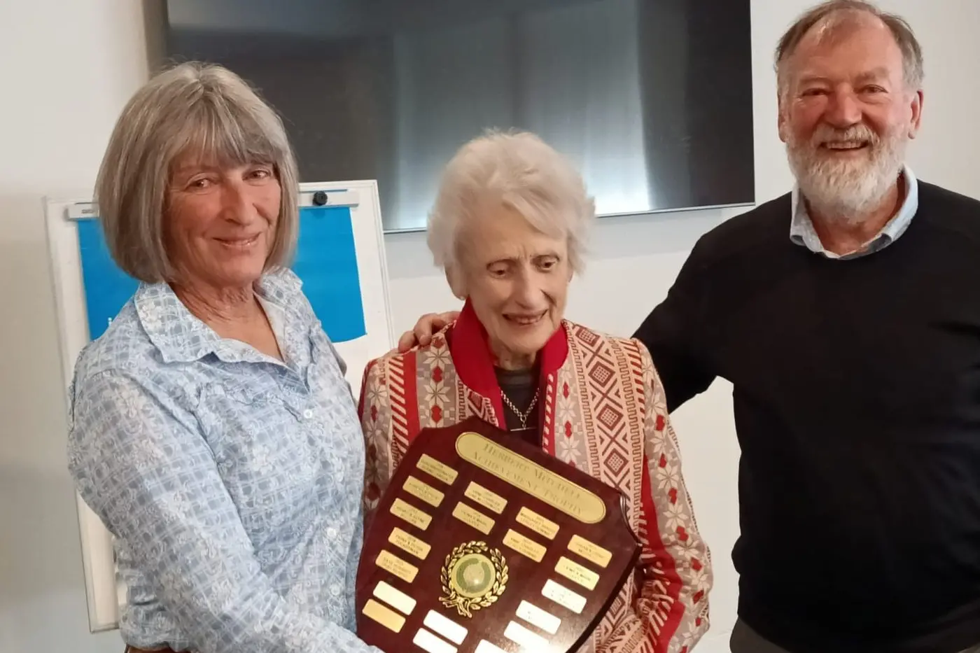 CHAMPIONS: Sue and Stephen Wallace are presented with the Herbert trophy by Joey Herbert. PHOTOS: Monaro Bridge Club