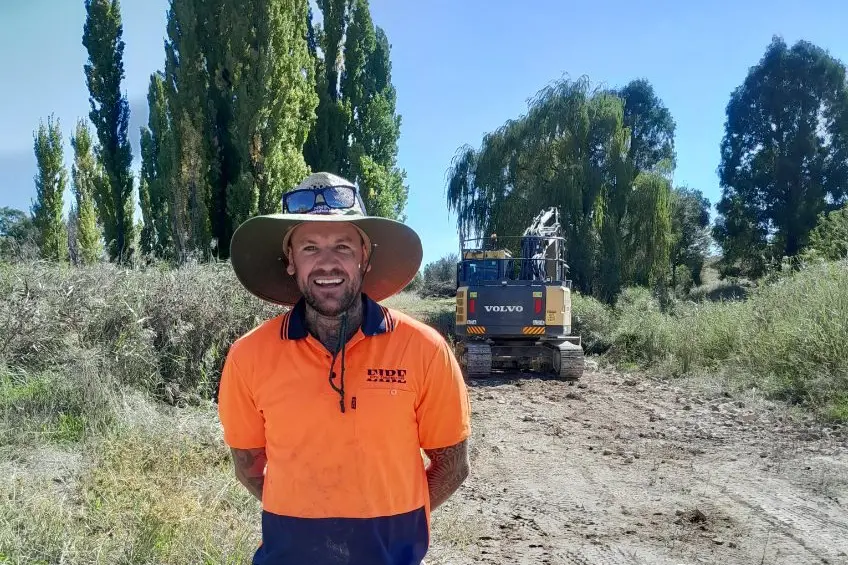 CONSTRUCTION: Stephen is all smiles as work begins on the new Michelago bridge. The bridge will connect residents of Micalago Road with the village. PHOTO: Supplied