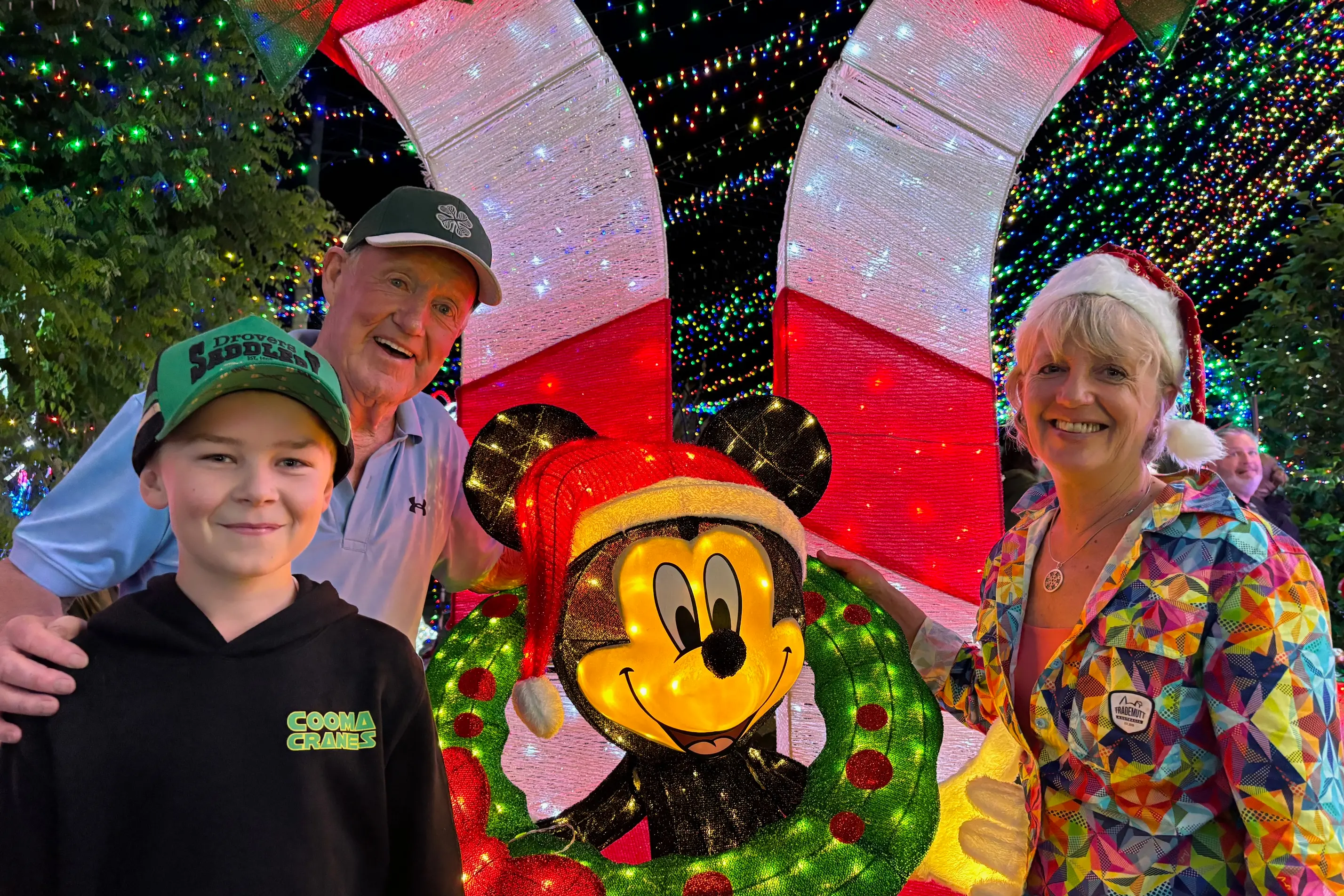<p>TRADITION: Postman John\\u2019s Jindabyne Christmas light display brings the whole community joy. Pictured last year are Postman John, his wife Doreen and young Ryan Rowson who has helped John with the display set up and with fundraising for many years. PHOTO: Trista Heath</p>\\n