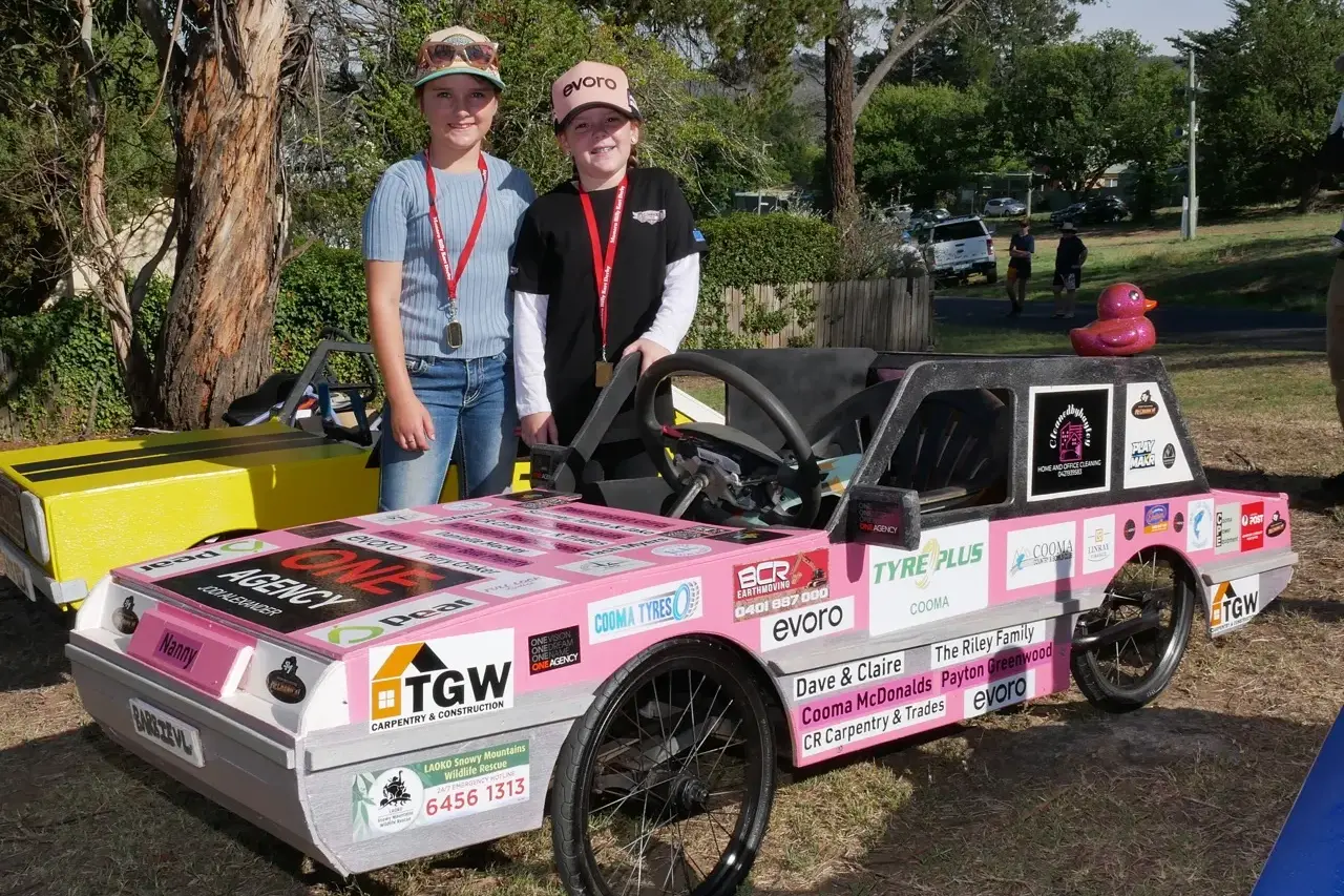 <p>COMMUNITY: Georgie and Quinn stand beside one the most popular carts of the derby. PHOTO: Cooma Car Club, Ross Lawley</p>\\n