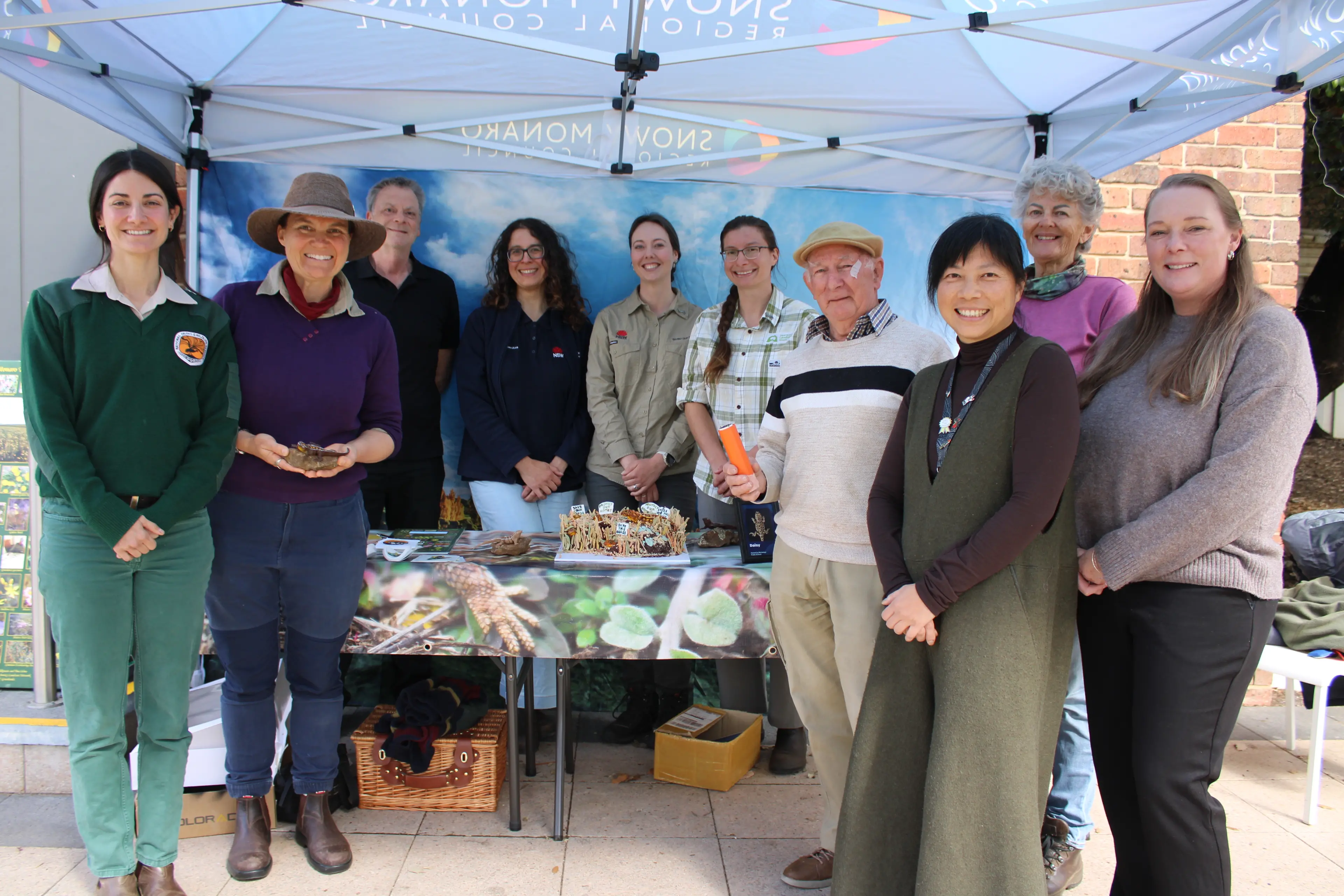 <p>DISPLAY: Launching the Monaro grassland earless dragon display are (back from left) Bill Walker, Alicia Kaylock local LLS, Monica Knipler Saving Our Species, Magdalene Lemcke Upper Snowy Landcare, (front from left) Lexi Arnold NPWS ranger, Melanie Sim DCCEEW, Rick Harris Cooma Men\\'s Shed, Kelly Chang of Cooma Visitor Centre, Renee Vincent of Landcare and Rebecca Hedger of Cooma Visitor Centre. PHOTO: Melinda Cairns Hack</p>\\n
