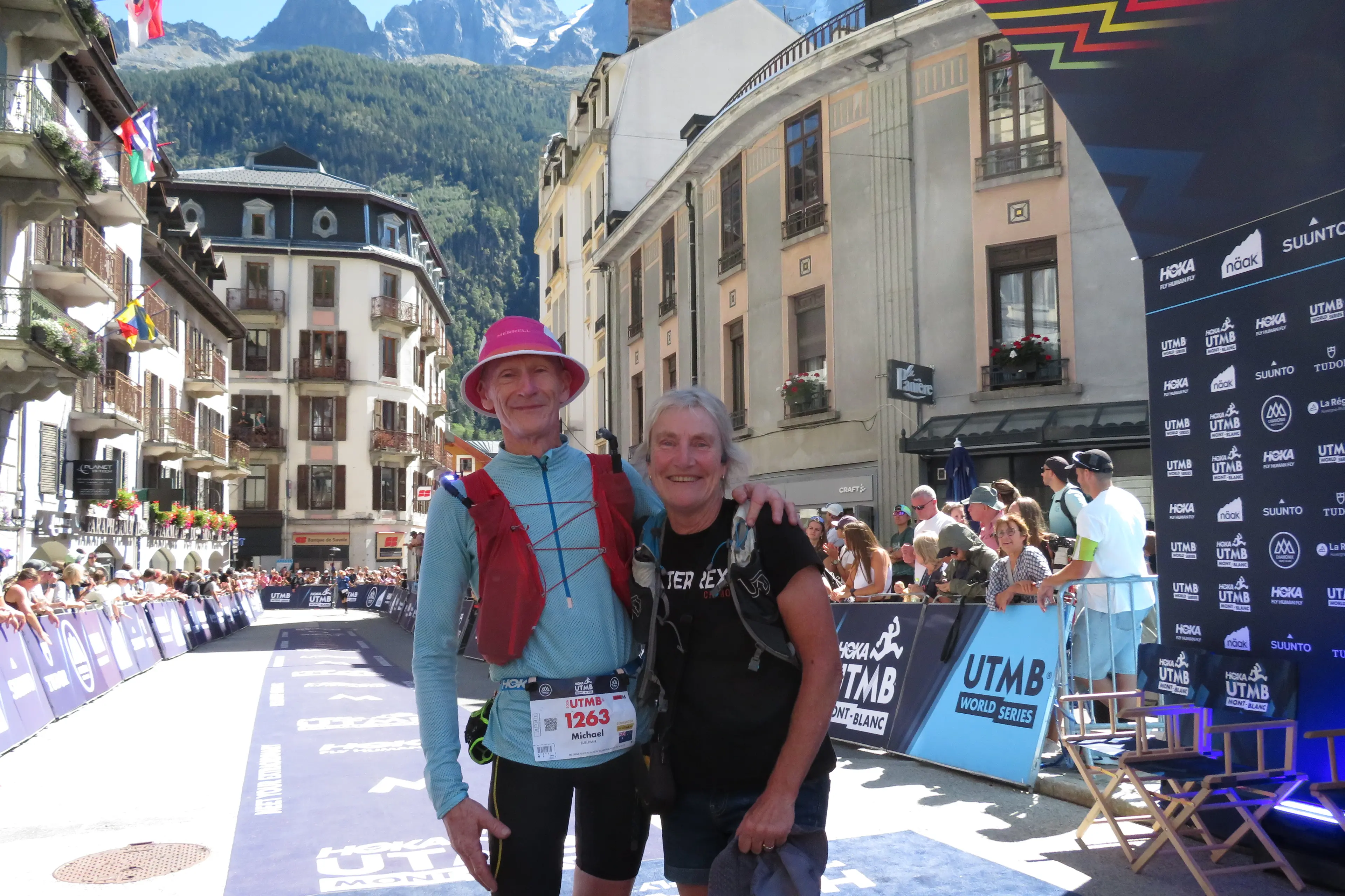 <p> WORLD CHAMP: Cooma\\'s Mick Sullivan is joined by wife, Jenny, after finishing first in the UTMB World Series final in the 65 years and older category in France. PHOTO: Supplied</p>\\n